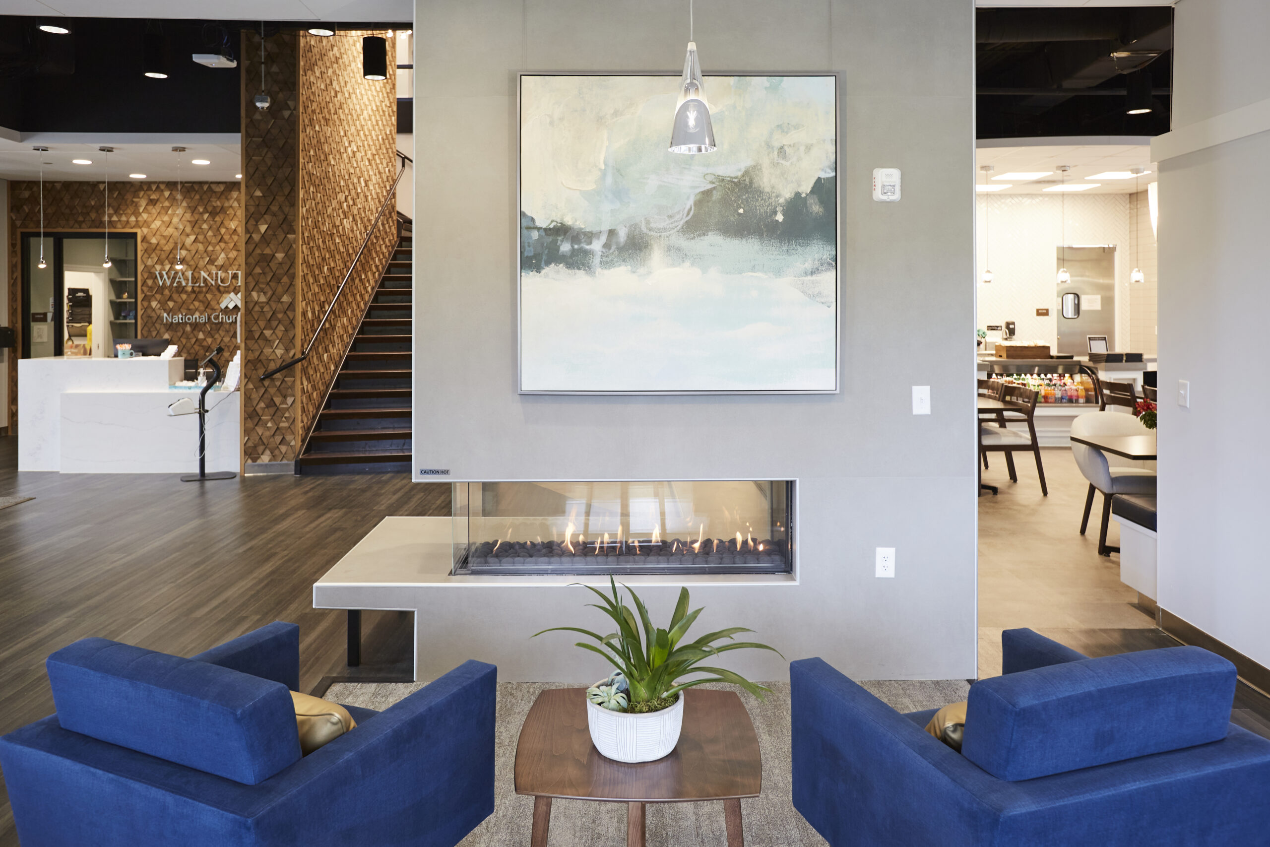 Lobby with fireplace and blue accent chairs