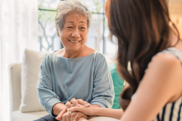 senior woman sitting with daughter