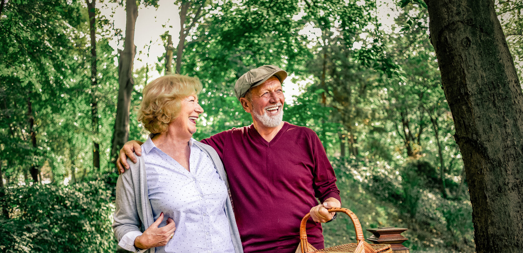 senior couple having quality time together in nature going for a picnic