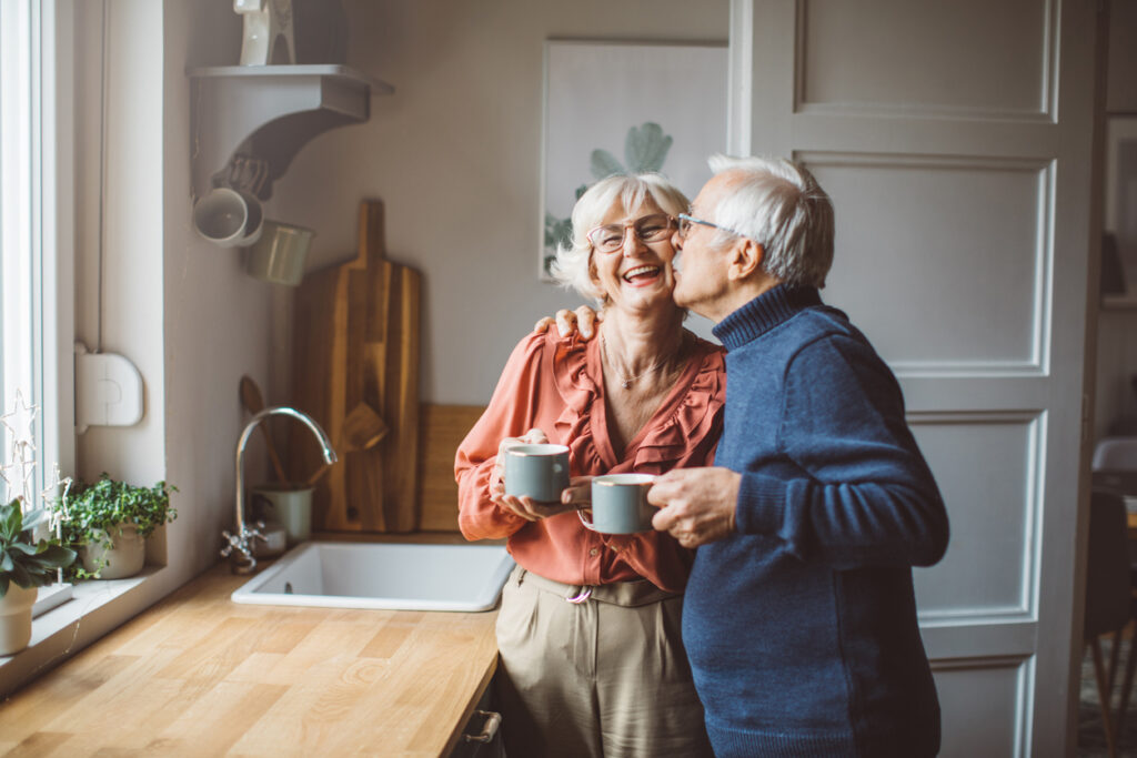Senior couple loving after making coffee