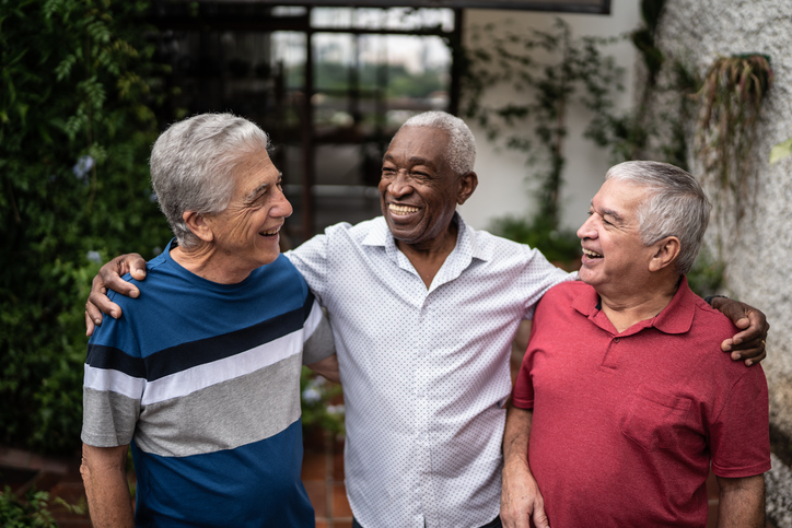 group of senior friends walking and talking together