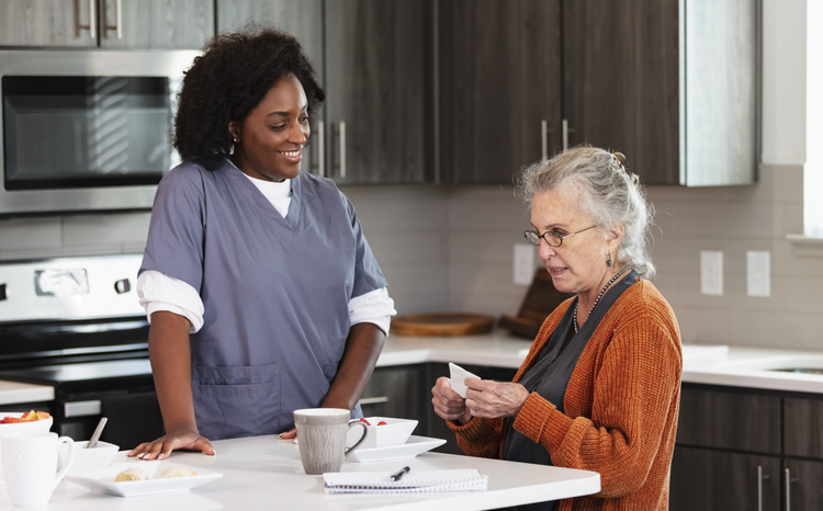 Senior with caregiver in the kitchen