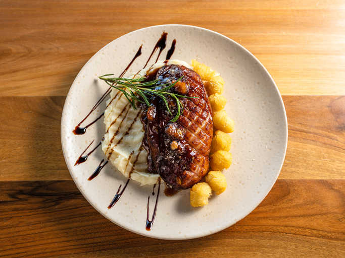 Close-up of a perfectly plated meal with meat and mashed potatoes