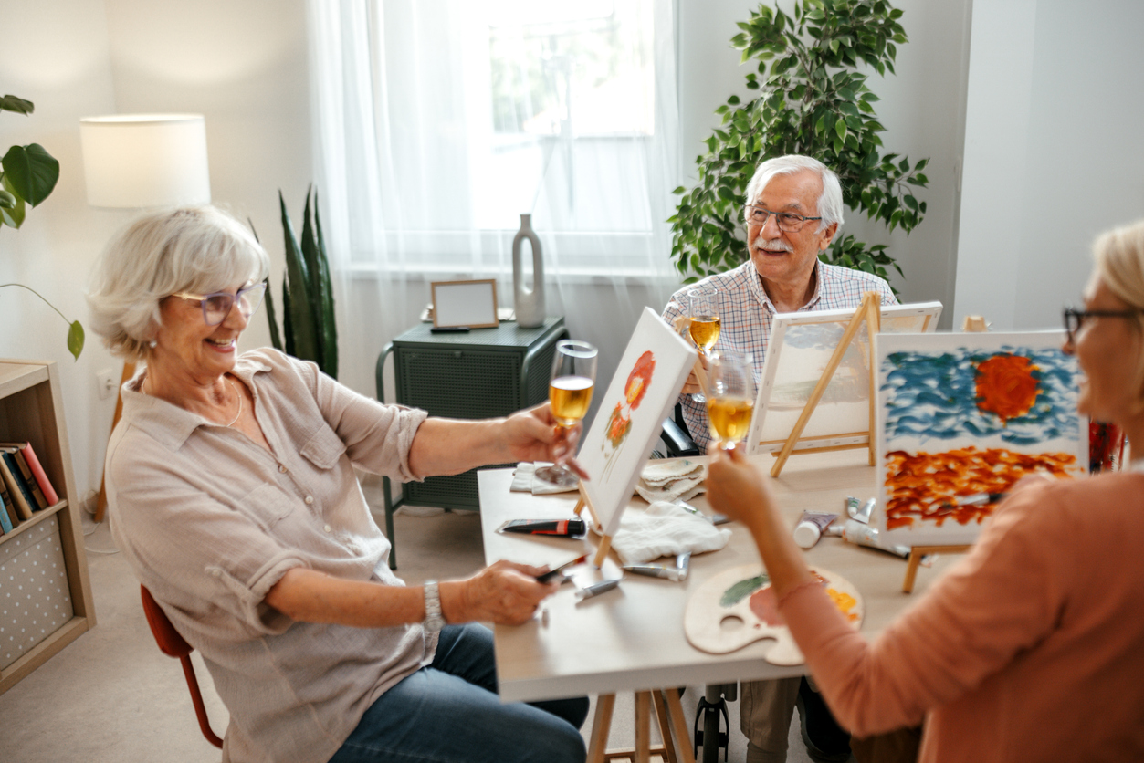 Senior couple smiling while looking at a tablet together