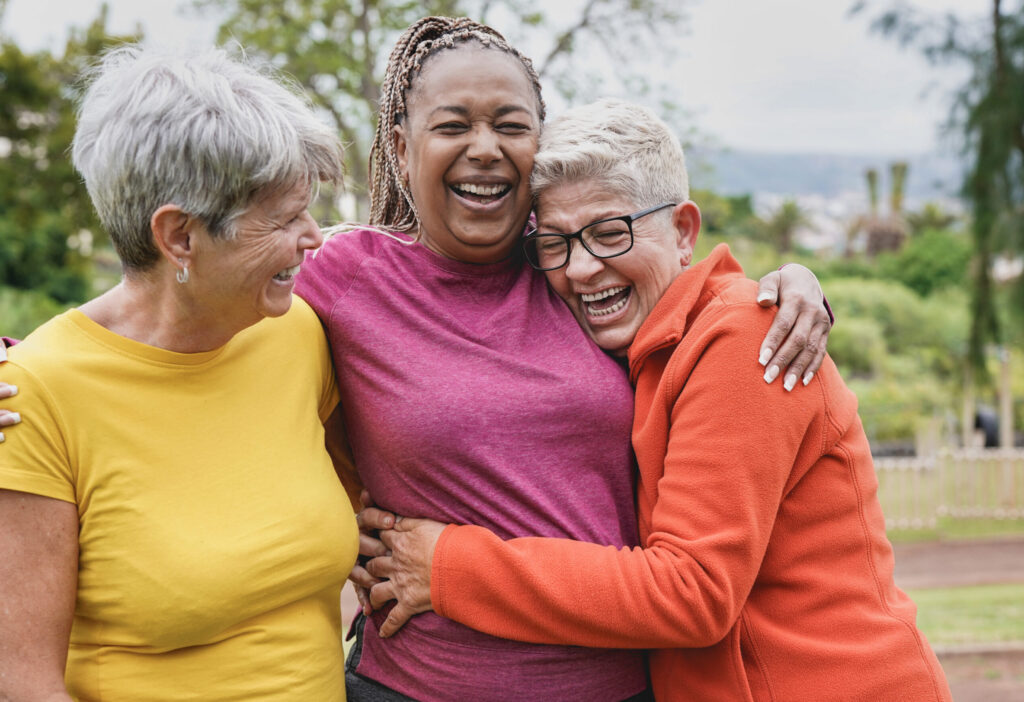 Senior friends smiling in park