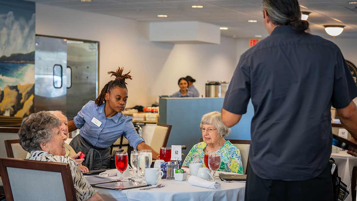 Waitress serving seniors in a dining room