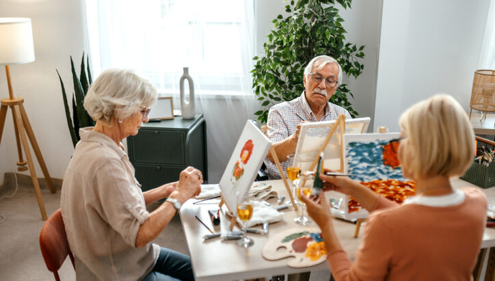 Group of senior residents, enjoying a painting session together.