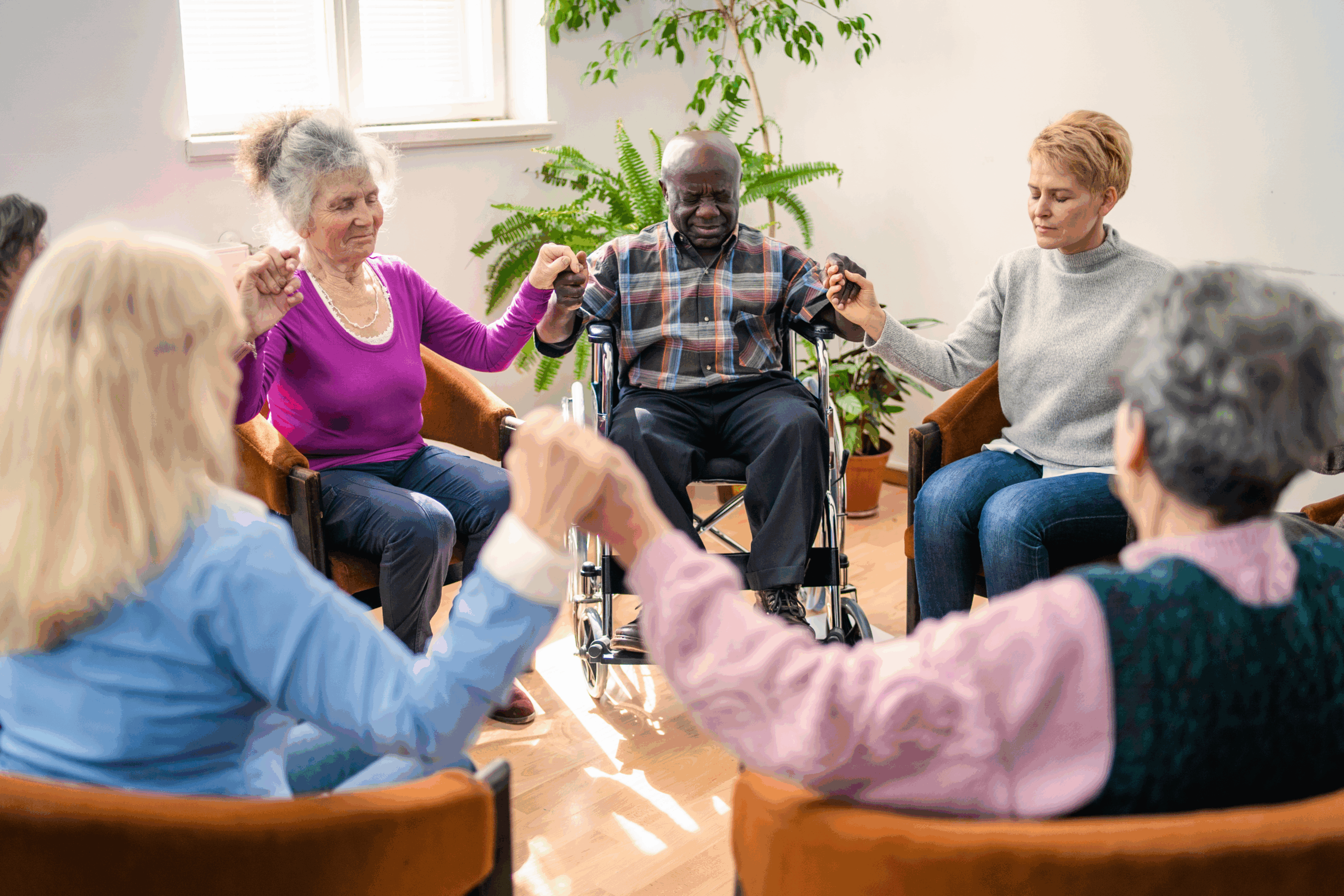 Seniors holding hands in group circle