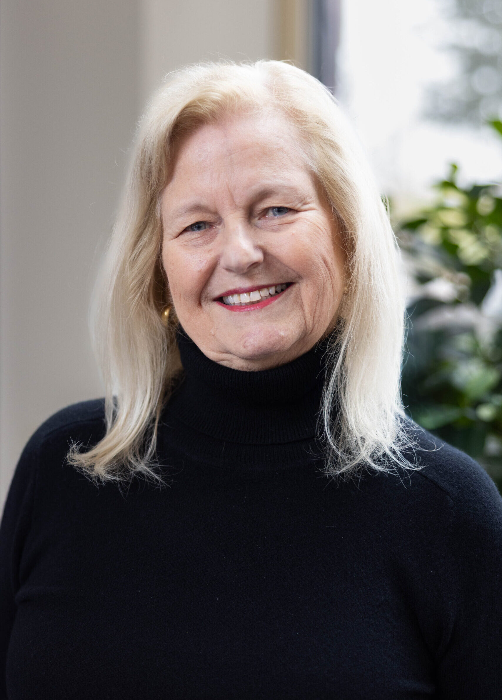 Older woman smiling in bright room