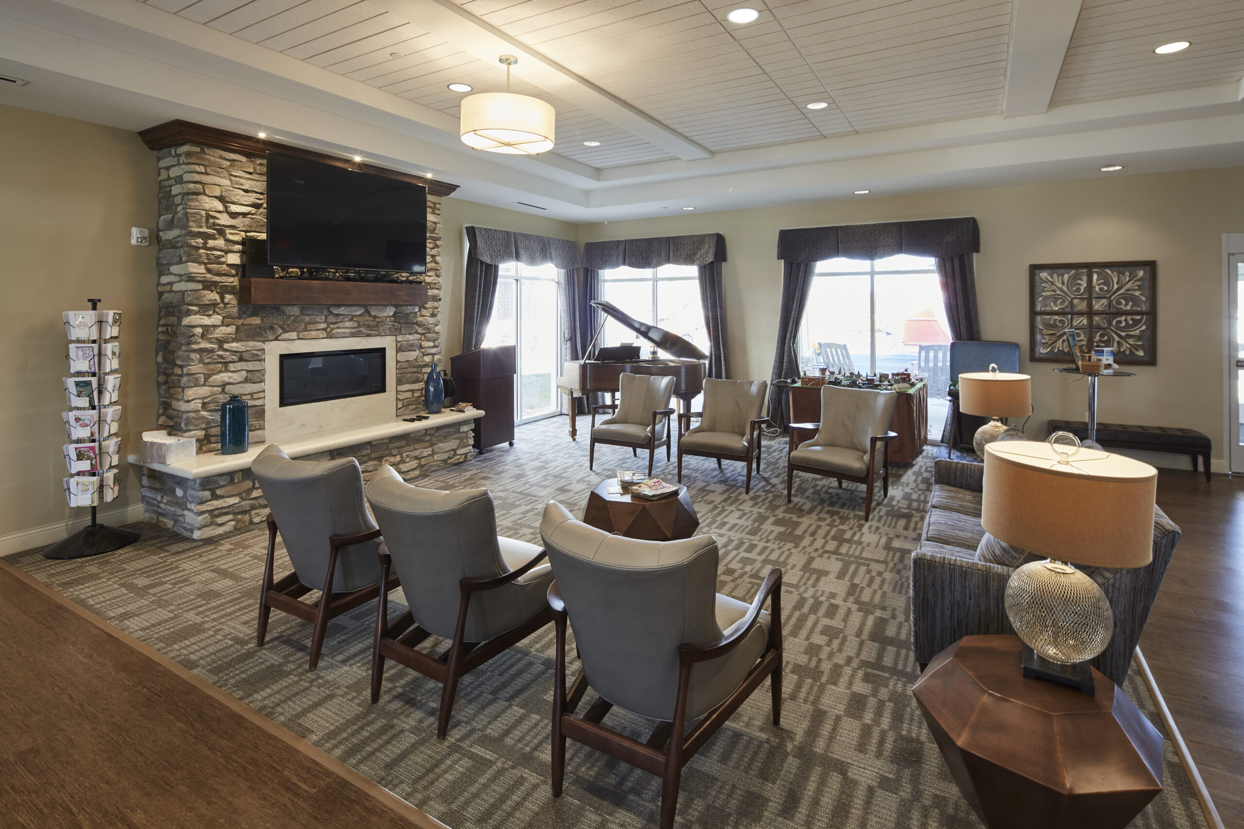 Sitting room lounge with fireplace and TV at Legacy Village